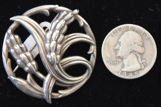 Vintage Dane craft circle pin with floral motif in sterling silver