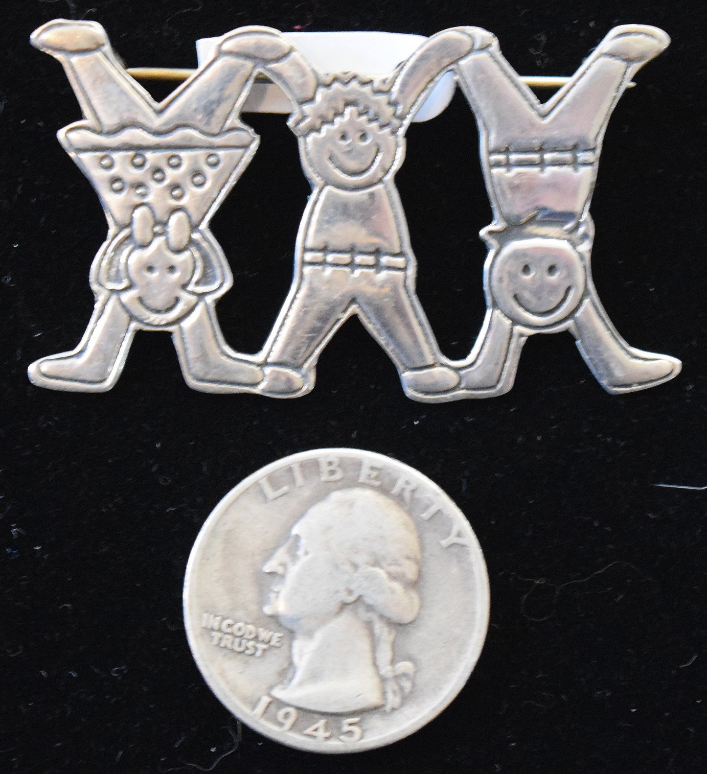 You'll turn flips over this vintage sterling silver pendant's featuring playful children.