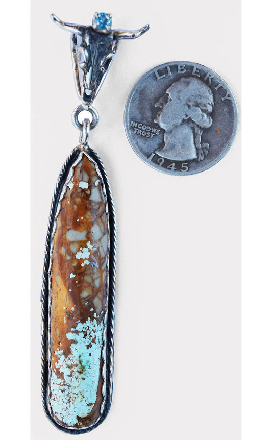 Take the bull by the horns and pick this stunning natural Nevada Turquoise stone with a blue topaz, mounted in Sterling Silver.