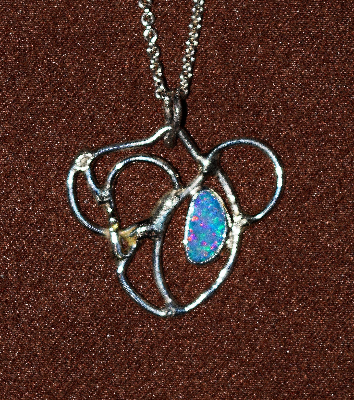 Handcrafted Sterling Silver pendant featuring an Opal gemstone and a 14K gold accent point. Includes a 18-inch Sterling necklace.