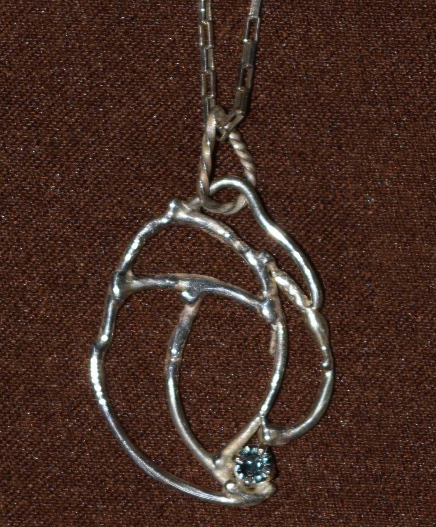 Handcrafted Sterling Silver pendant featuring a pastel blue Sapphire. Includes a 16-inch Sterling necklace.
