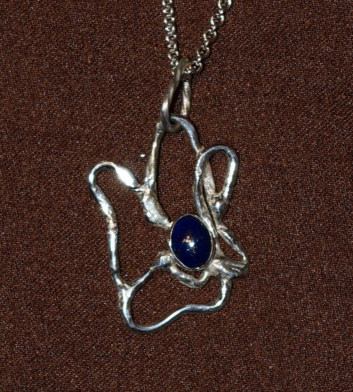 Handcrafted Sterling Silver pendant featuring a Lapis Lazuli gemstone. Includes a 18-inch Sterling necklace.