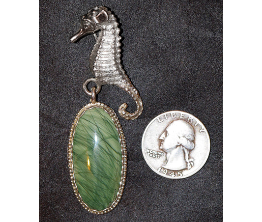 A serene seahorse hovers near what looks like seagrass captured in a stone. Featuring rare ?Mexican Imperial Jasper?.