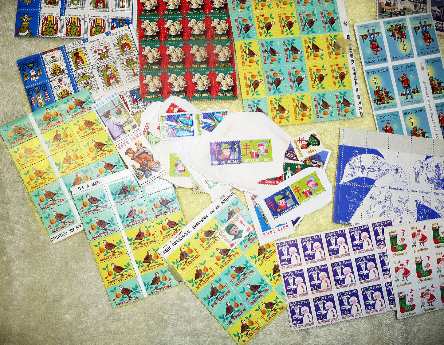 17 full sheets of 1960s and 1970s Christmas and Easter seals, Boy's Town seals, and featuring a sheet of 1966 NAACP Christmas seals!