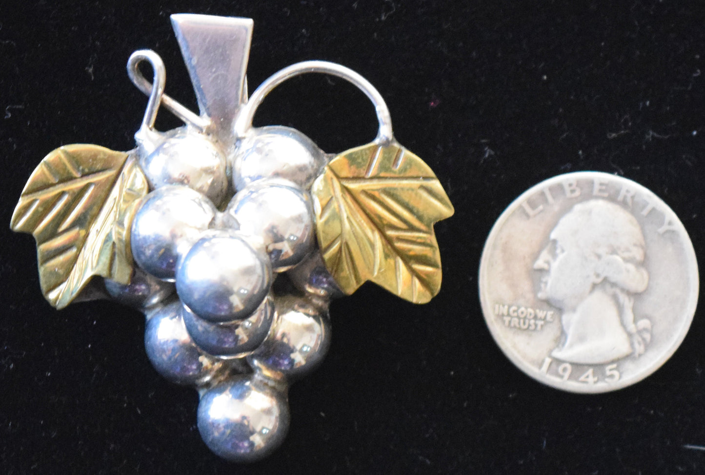 For the serious wine lover, a vintage sterling silver pin/pendant with 14 carat gold vermeil leaves.