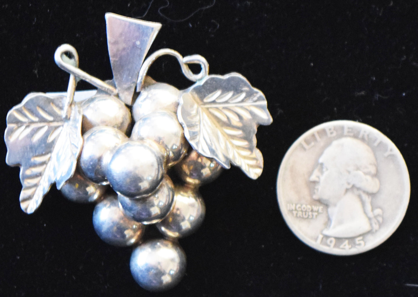 Heavy 1970s pin/pendant featuring grape leaf and grapes in sterling silver.
