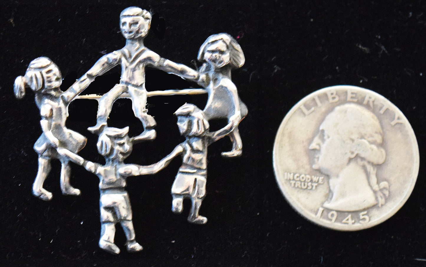Vintage pin  in sterling silver with children playing.