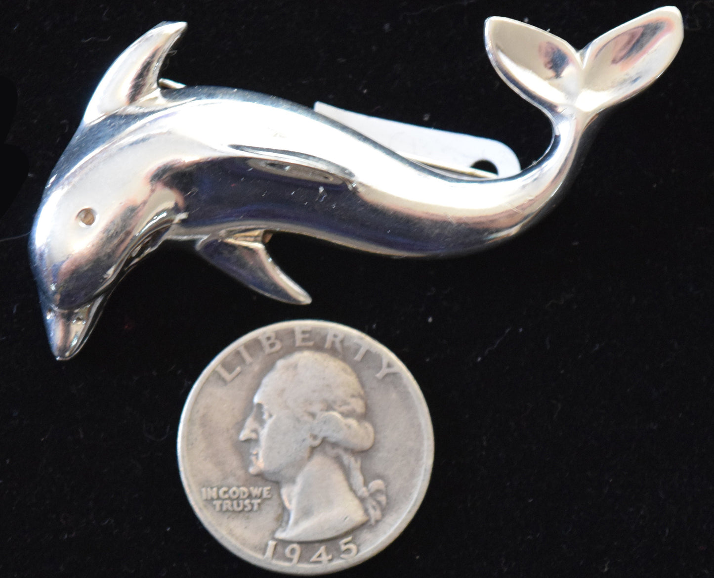 Graceful vintage dolphin pin in heavy sterling silver.