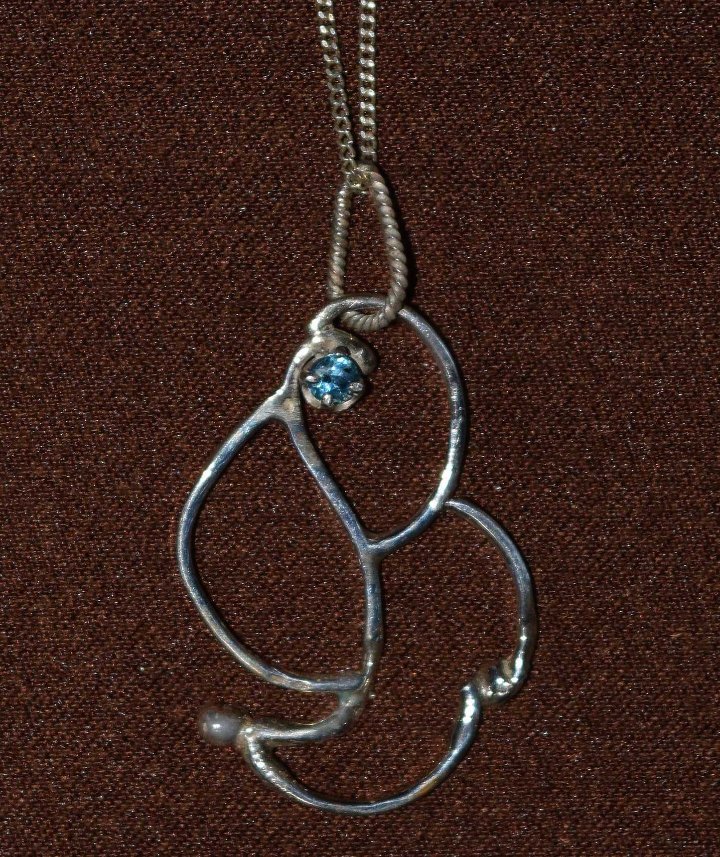 Handcrafted Sterling Silver pendant featuring a Blue Topaz stone.