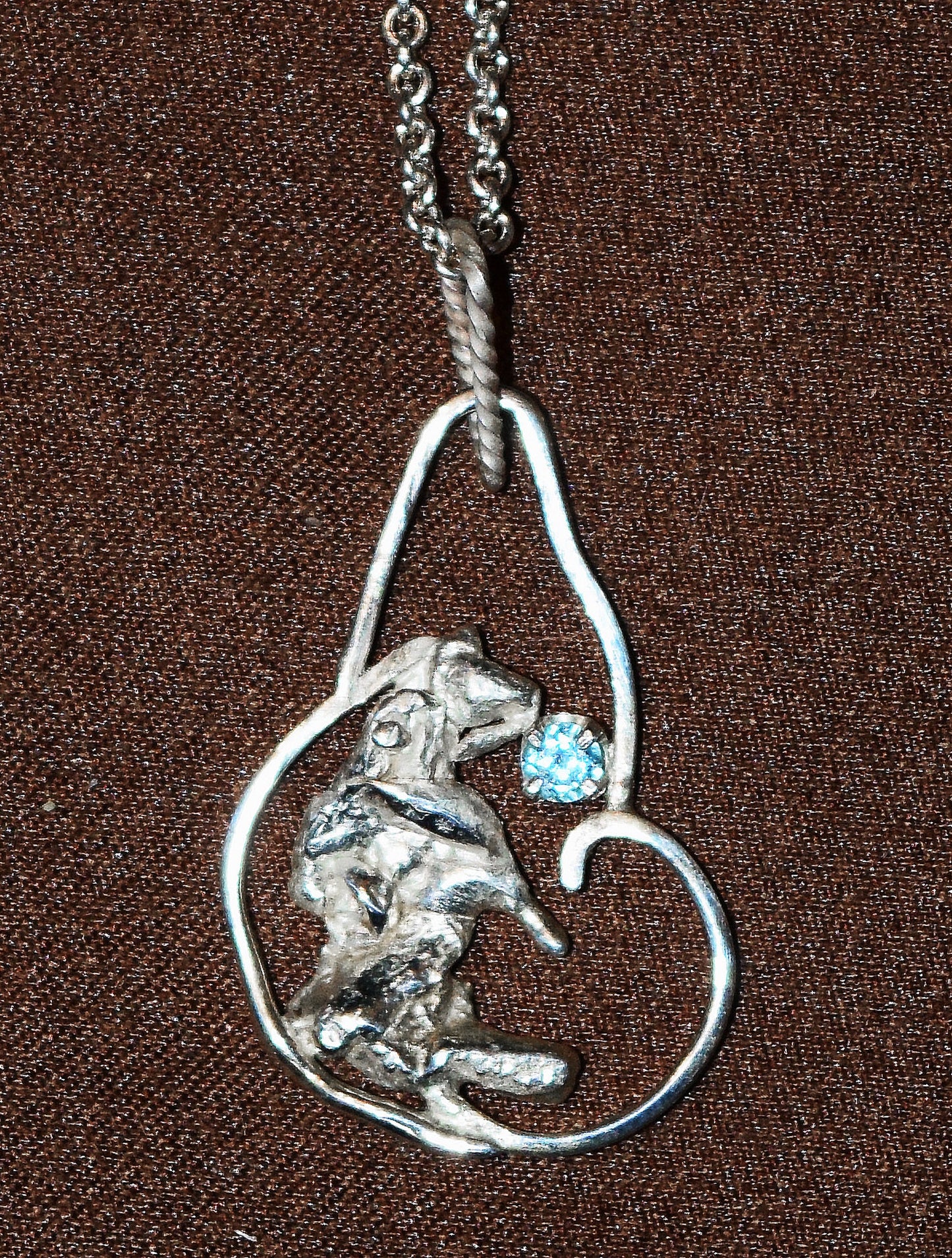 Handcrafted Sterling Silver pendant featuring a Blue Topaz gemstone. Includes a 18-inch Sterling necklace.