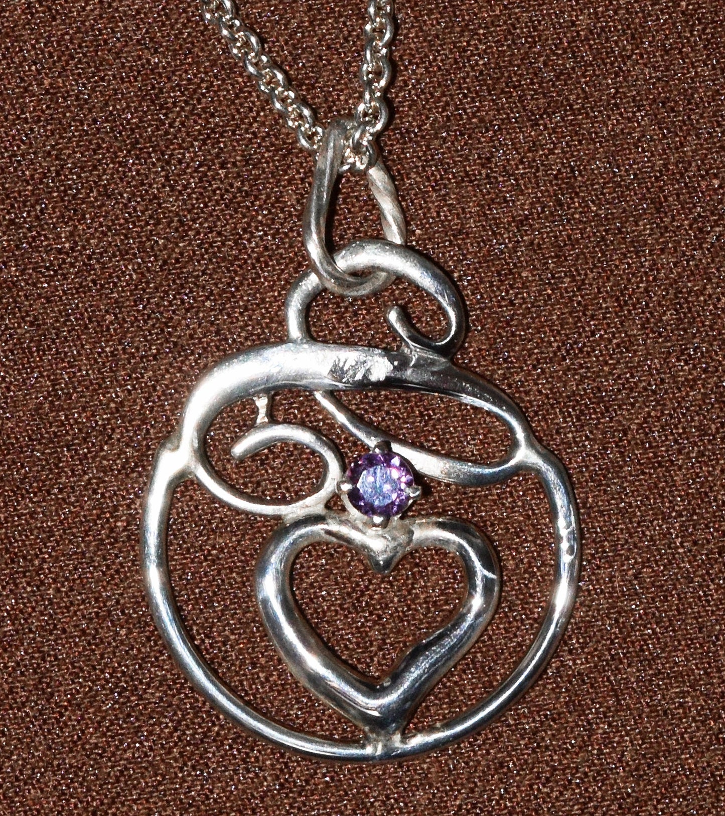 Handcrafted Sterling Silver pendant featuring a Tanzanian Sapphire. Includes a 18-inch Sterling necklace