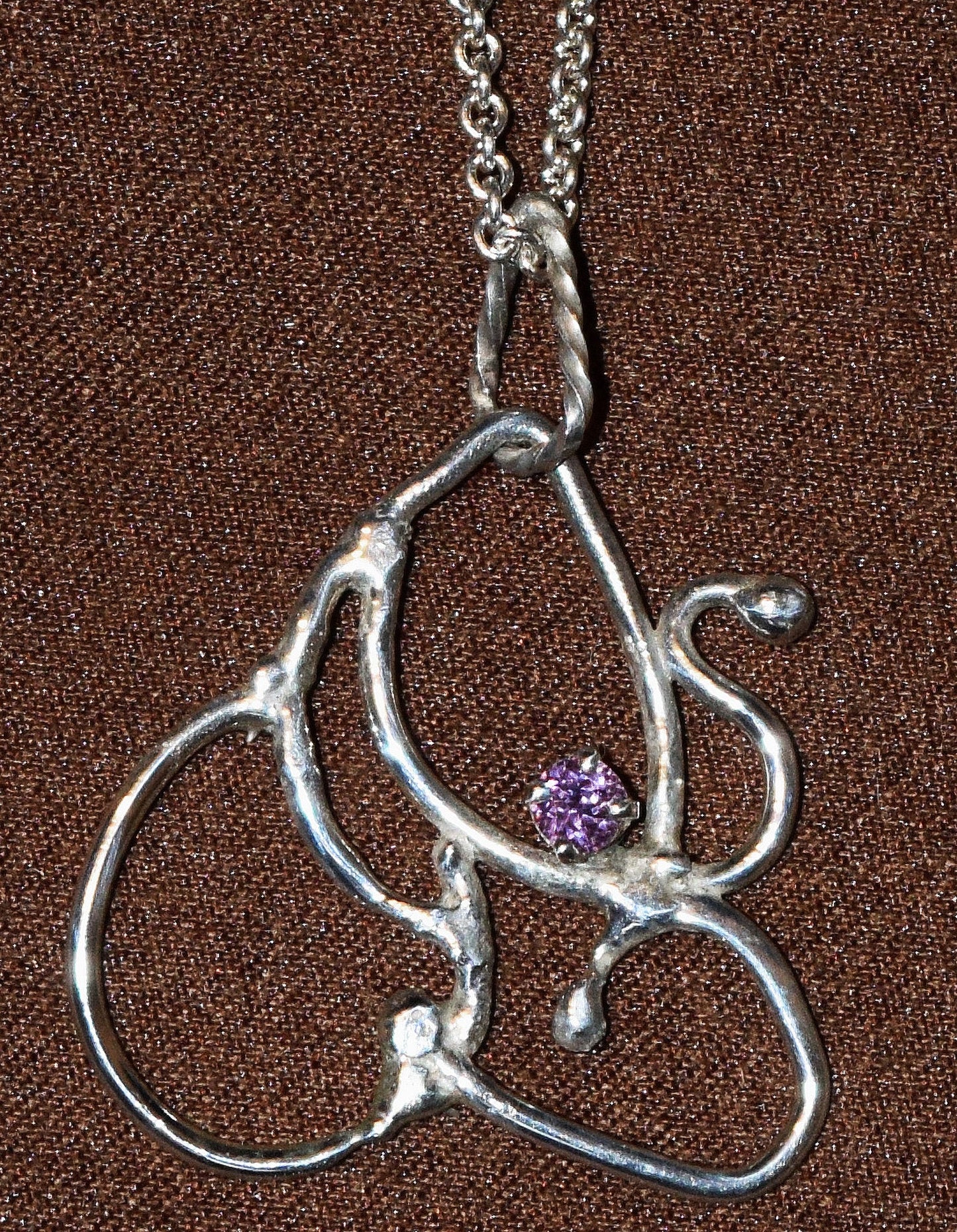 Handcrafted Sterling Silver pendant featuring a rare, purple Tanzanian Sapphire gemstone. Includes a 18-inch Sterling necklace.
