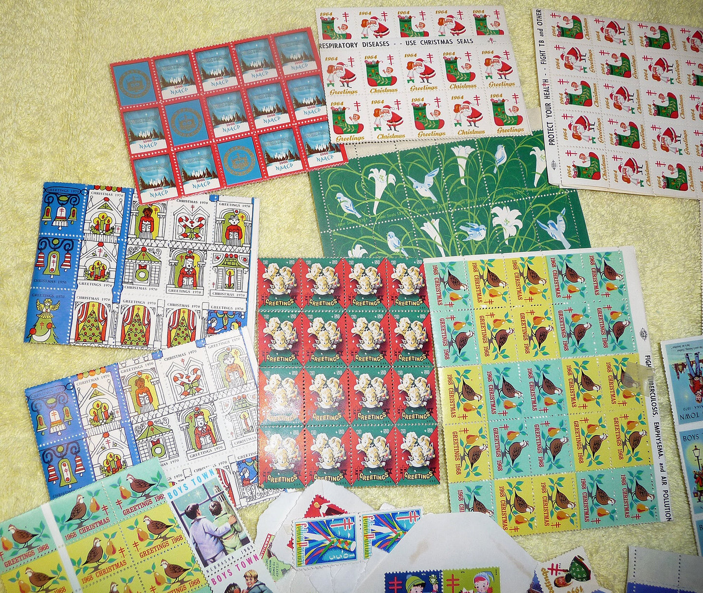 17 full sheets of 1960s and 1970s Christmas and Easter seals, Boy&#39;s Town seals, and featuring a sheet of 1966 NAACP Christmas seals!